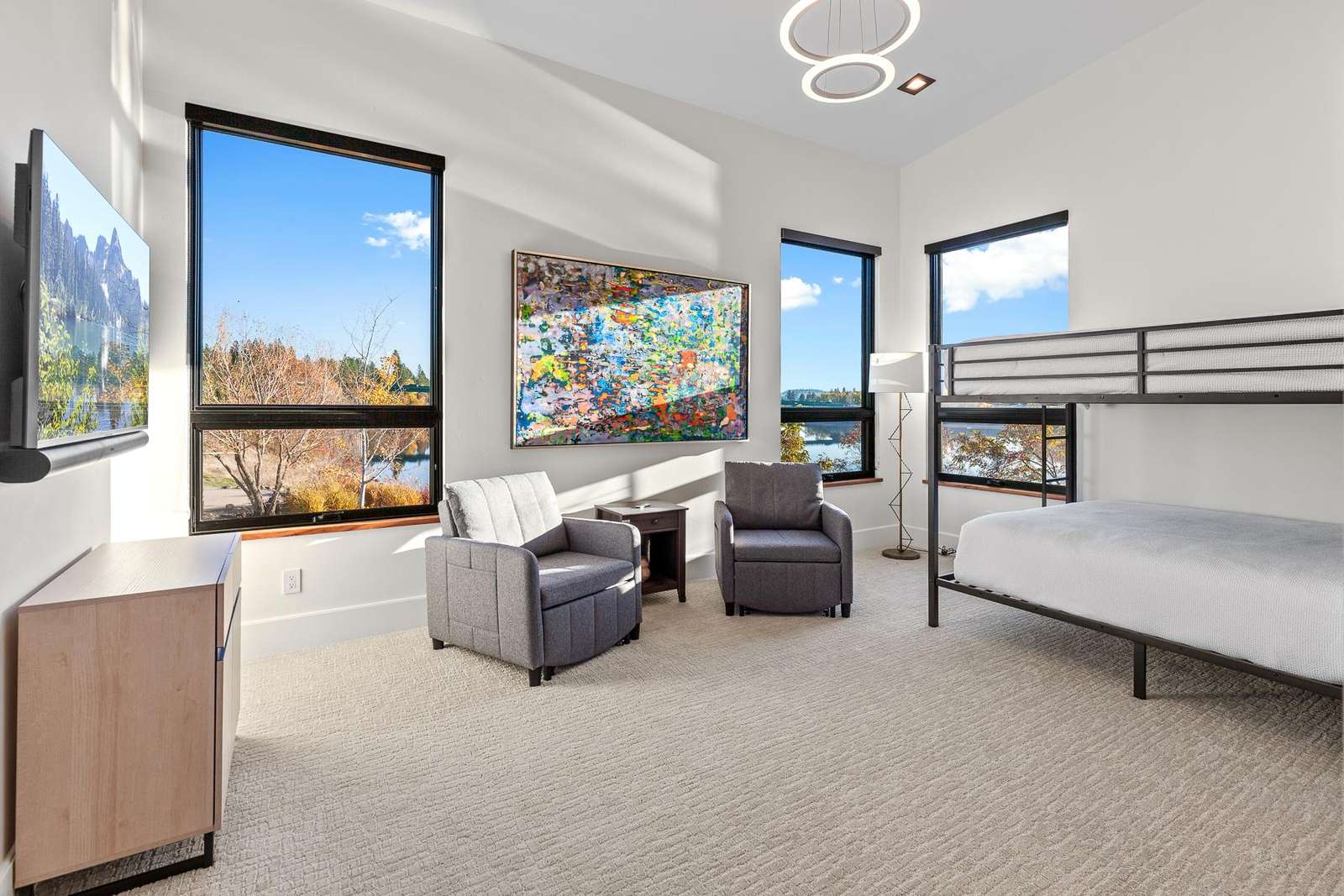 Bright bunk room with scenic views and cozy seating area