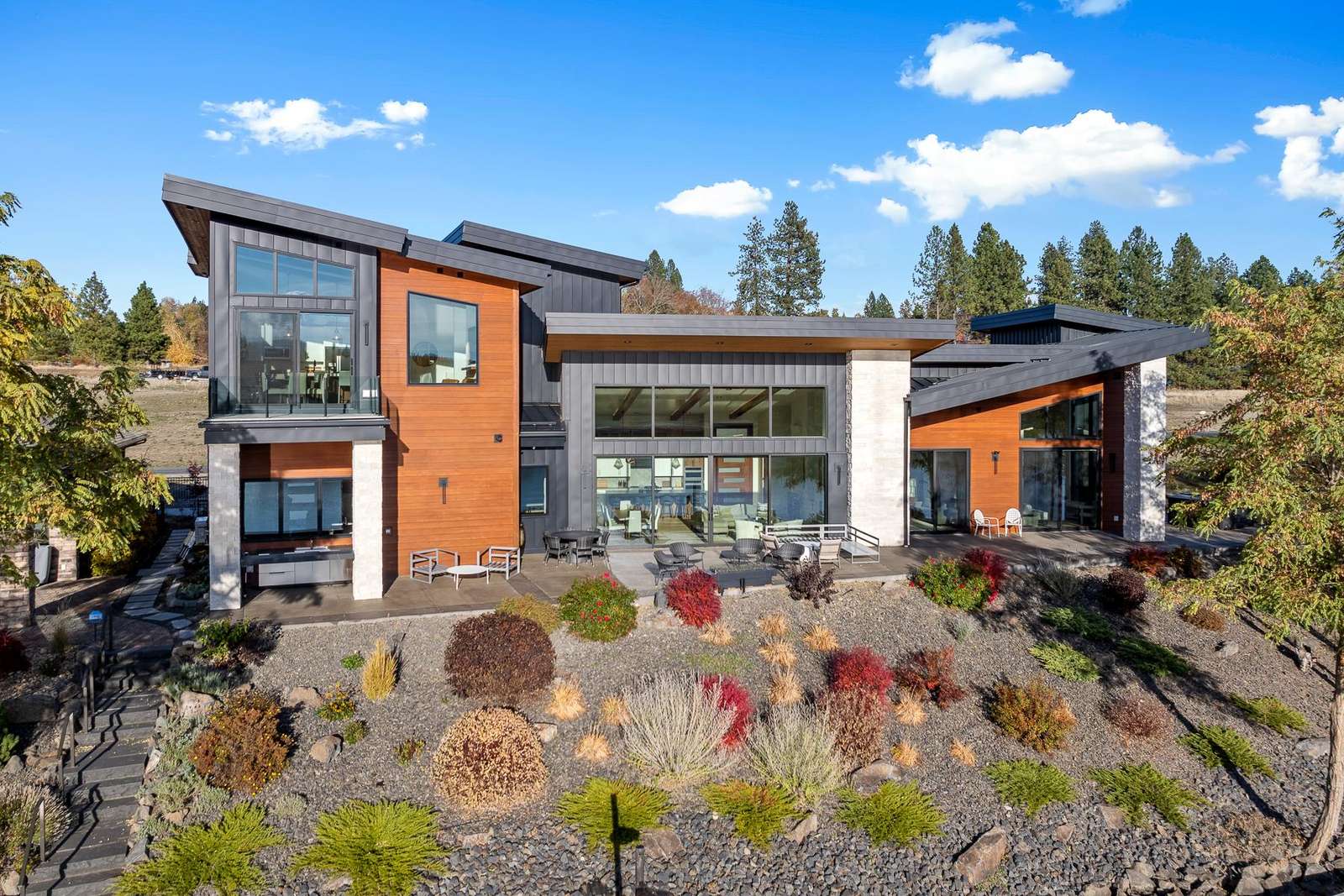 Modern hillside retreat with panoramic glass views and spacious decks