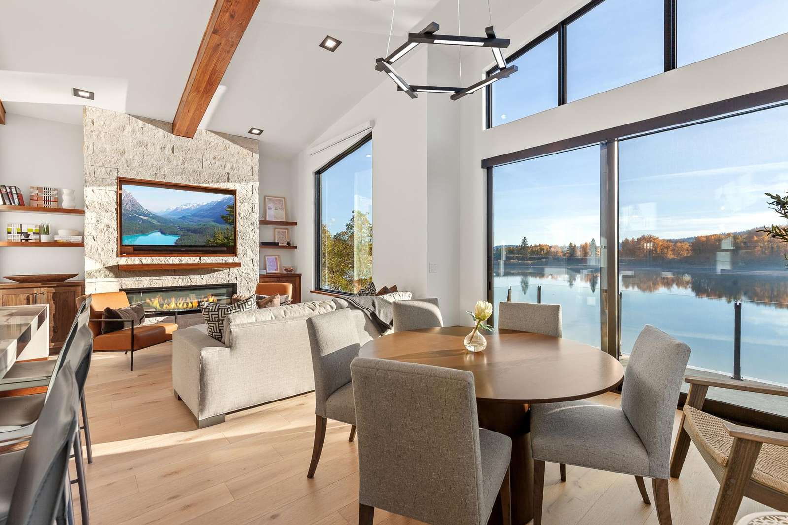 Sunlit living and dining area with stunning waterfront views