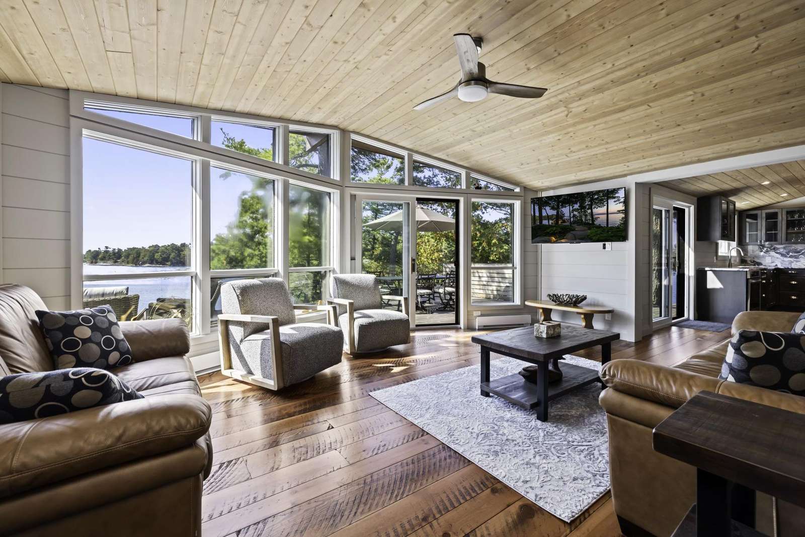 Sunlit living room with panoramic lake views and cozy seating