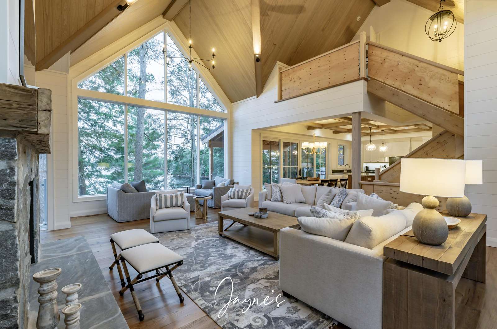 Spacious living room with soaring windows and cozy fireplace