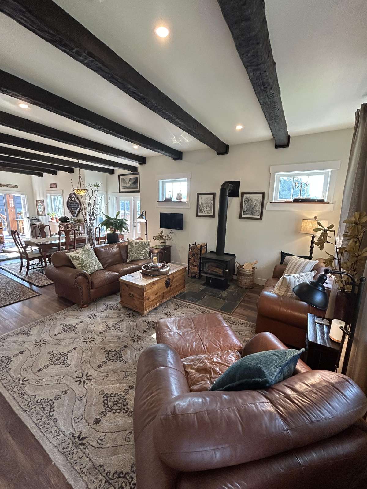 Cozy living room with rustic beams and leather seating