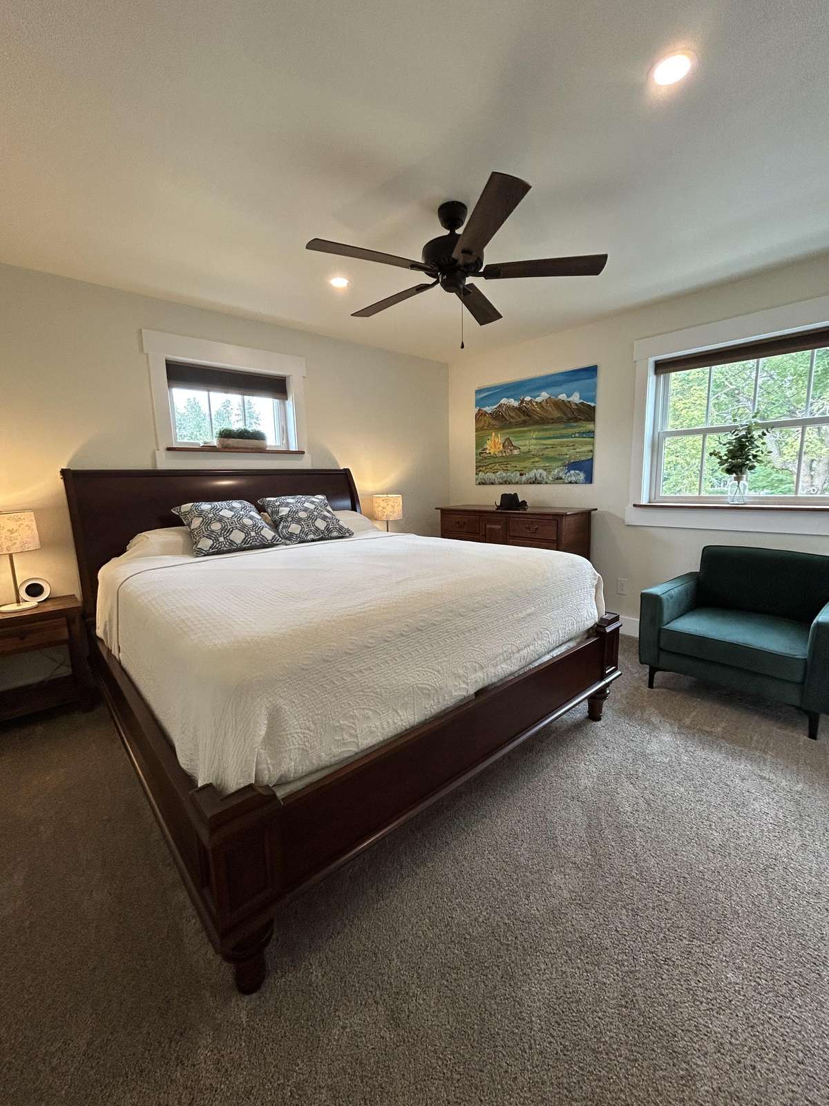 Spacious bedroom retreat with cozy seating and natural light
