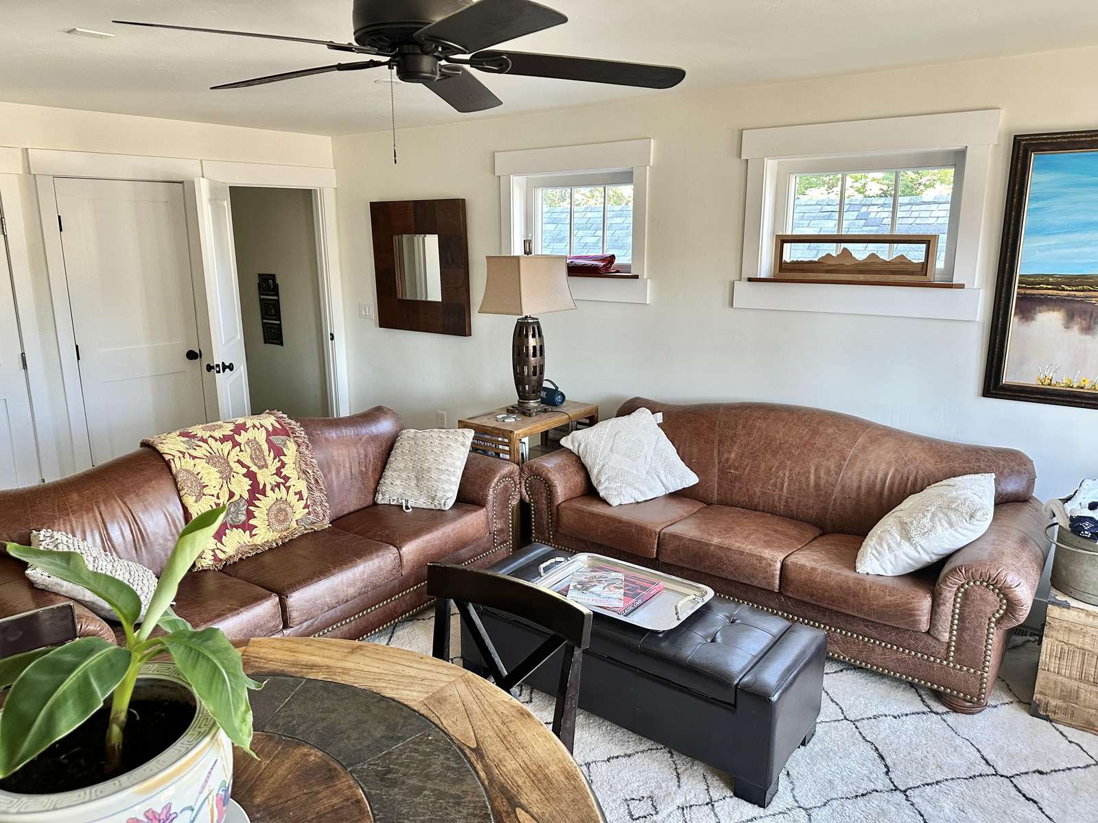 Cozy living room with plush leather sofas and natural light