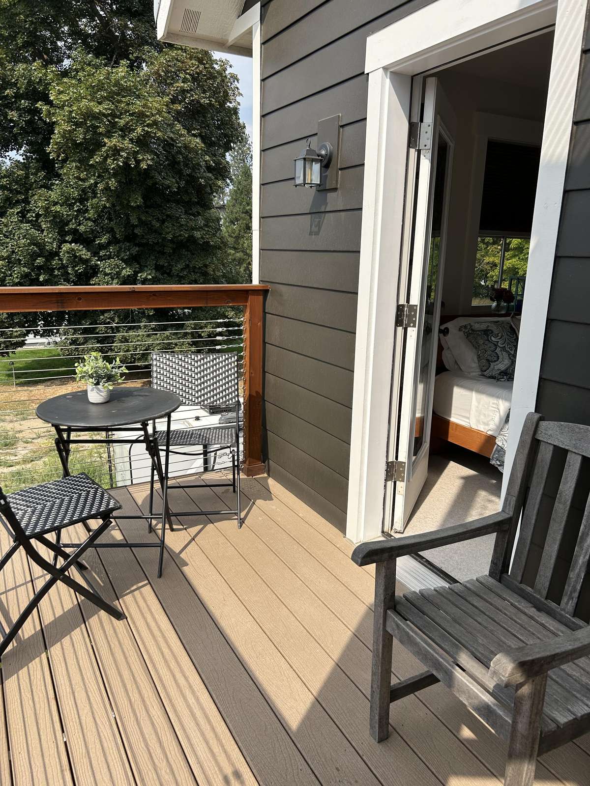 Sunny deck with cozy seating and peaceful garden views