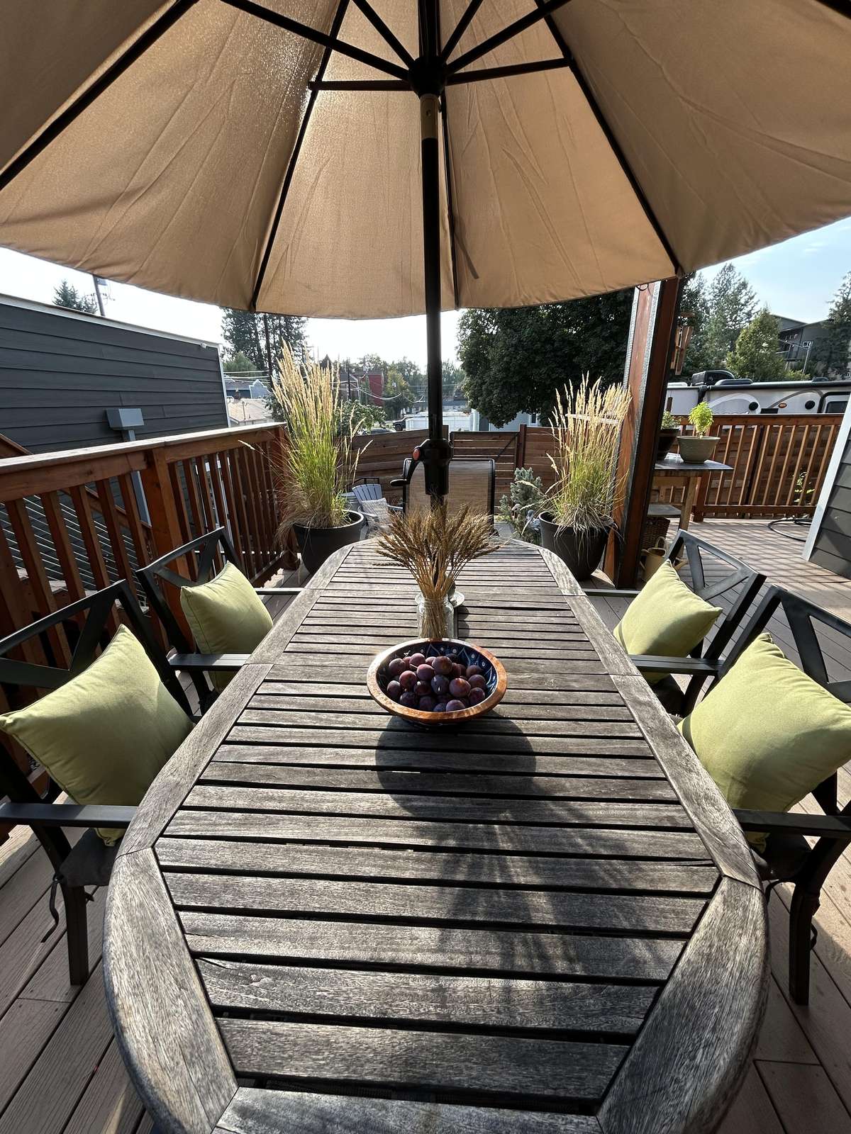 Sunlit patio dining with cozy cushions and umbrella shade