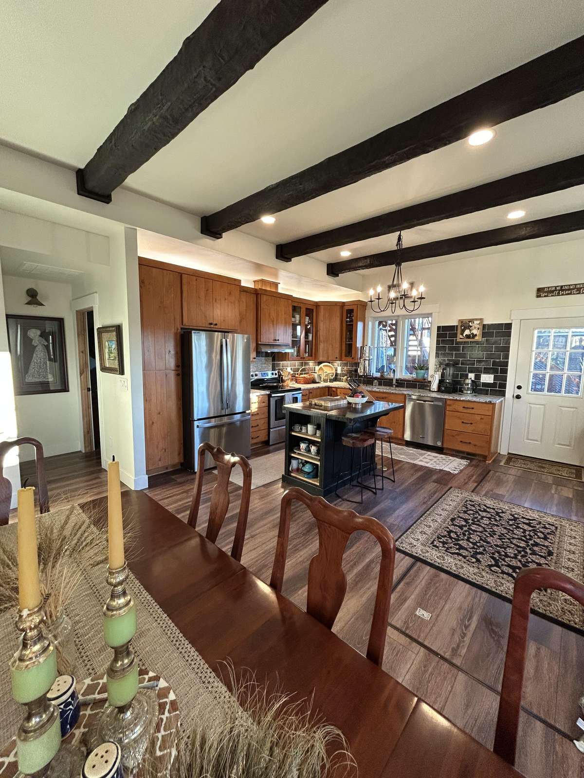 Spacious kitchen and dining area with rustic charm and natural light
