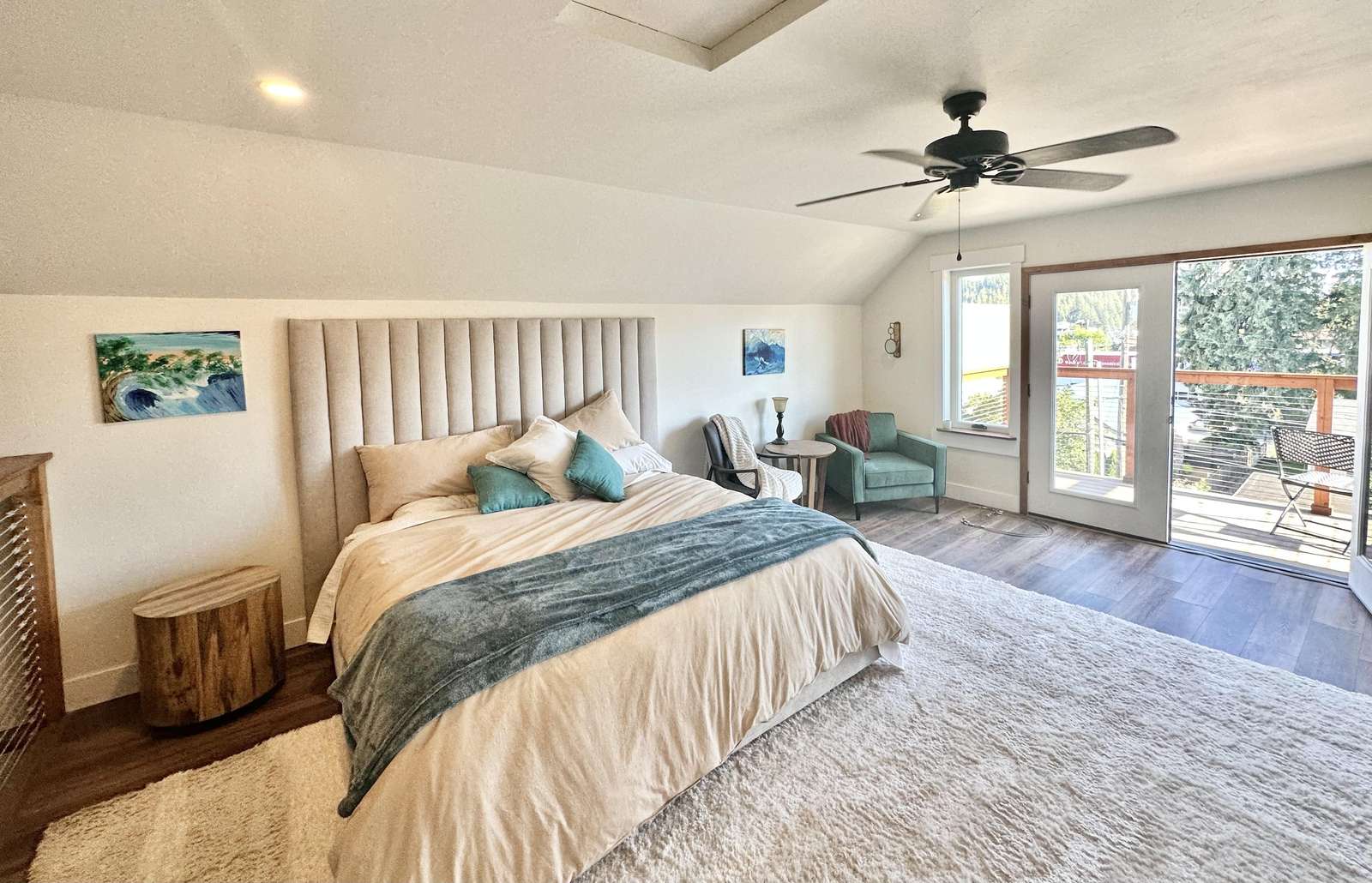 Spacious bedroom with cozy seating and private patio access