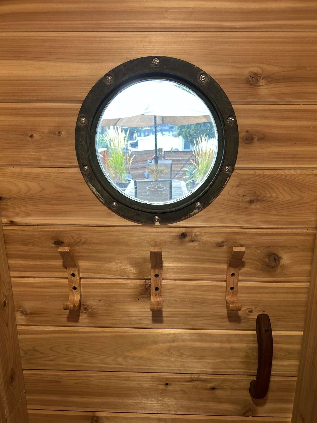Cozy sauna with charming porthole window view