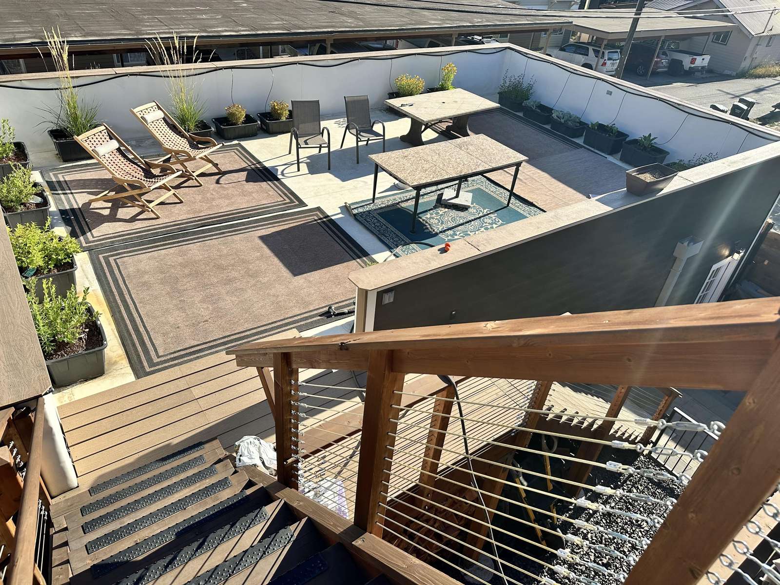 Spacious patio above garage with cozy seating and sun loungers