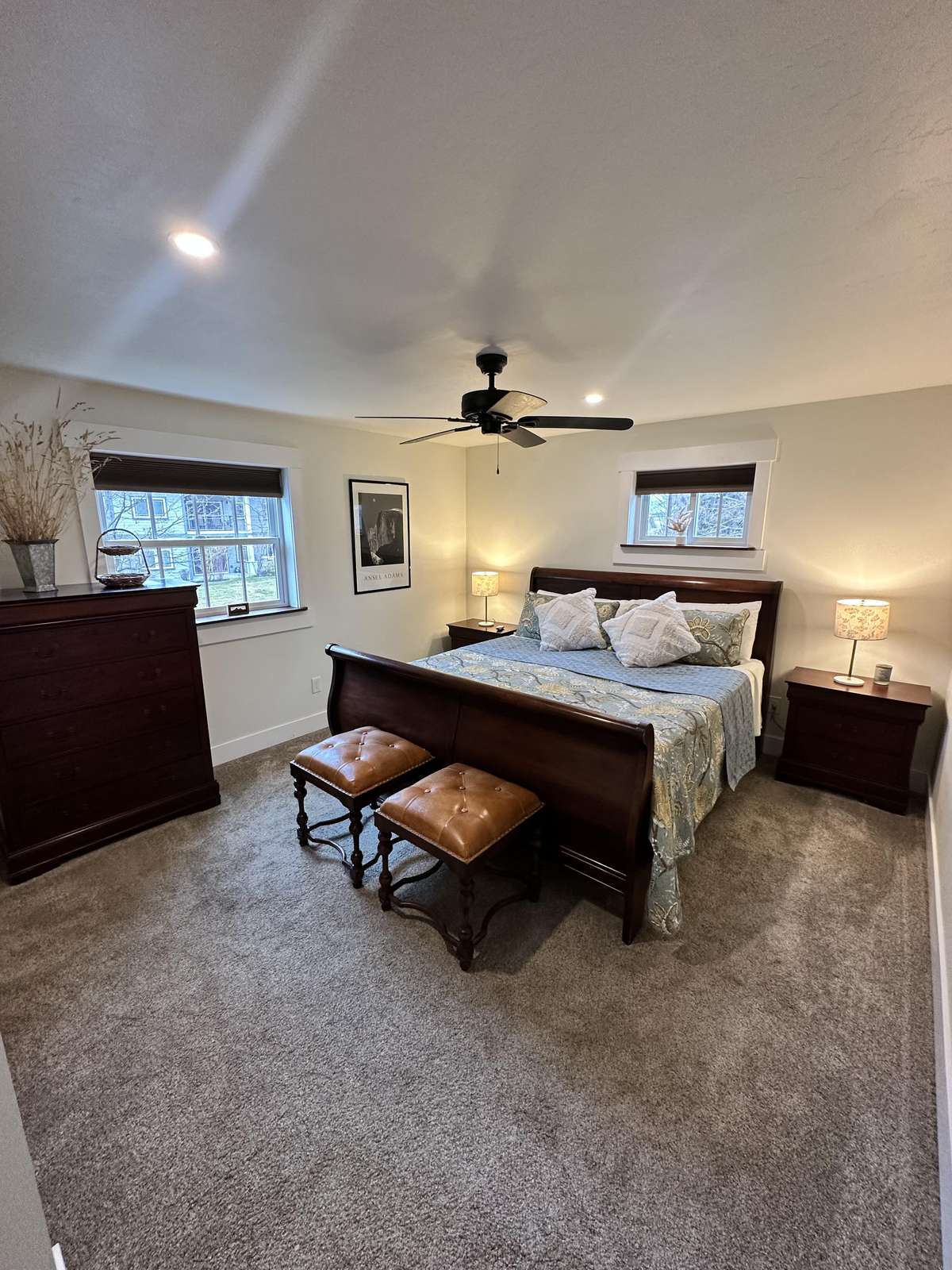 Spacious bedroom with cozy seating and natural light