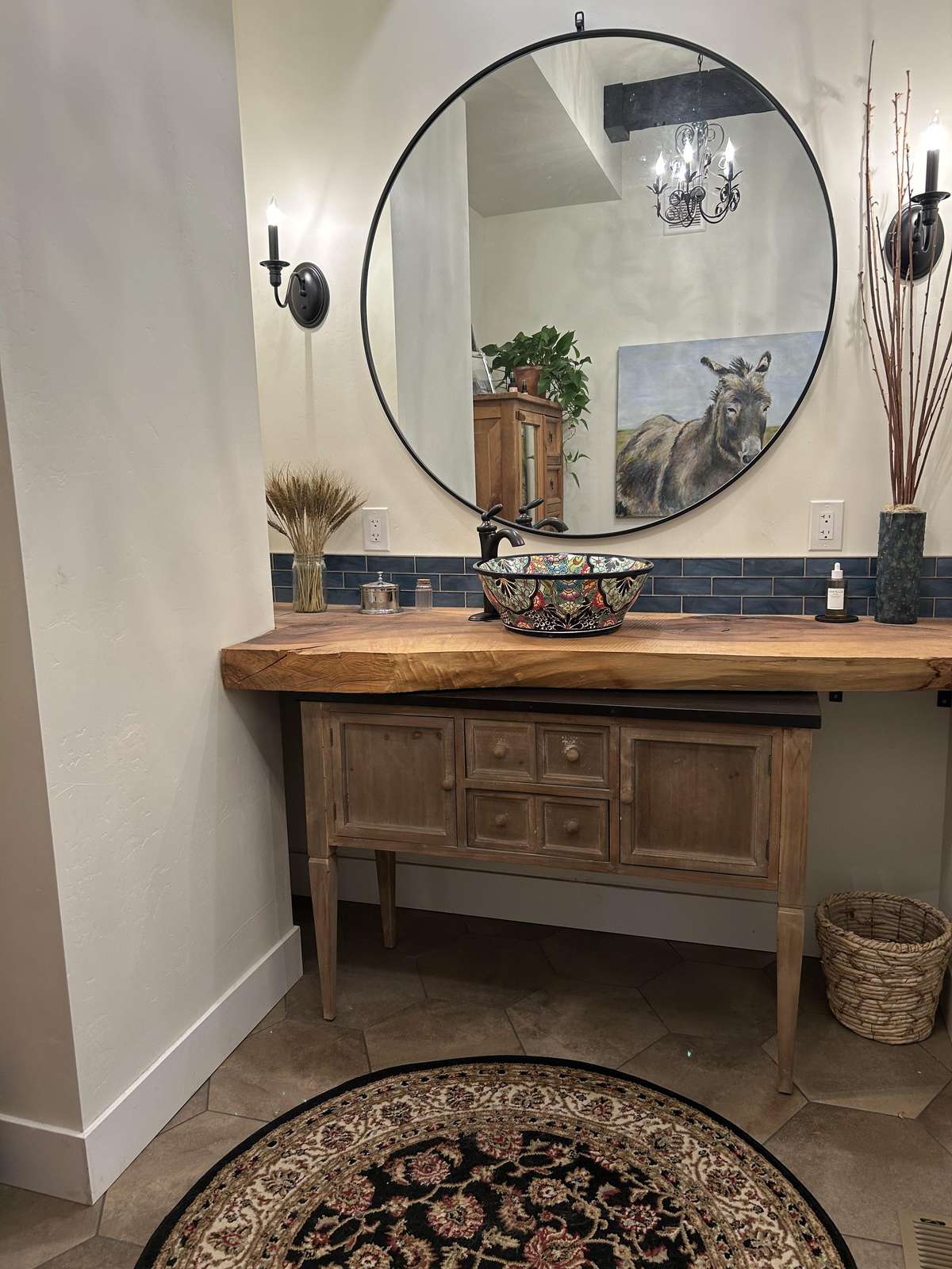 Charming rustic bathroom with warm wood vanity and elegant round mirror