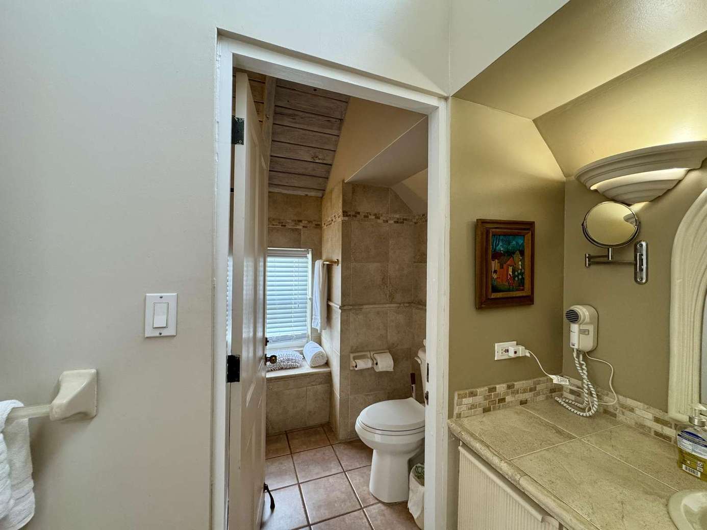 Bright, modern bathroom with elegant stone accents and natural light