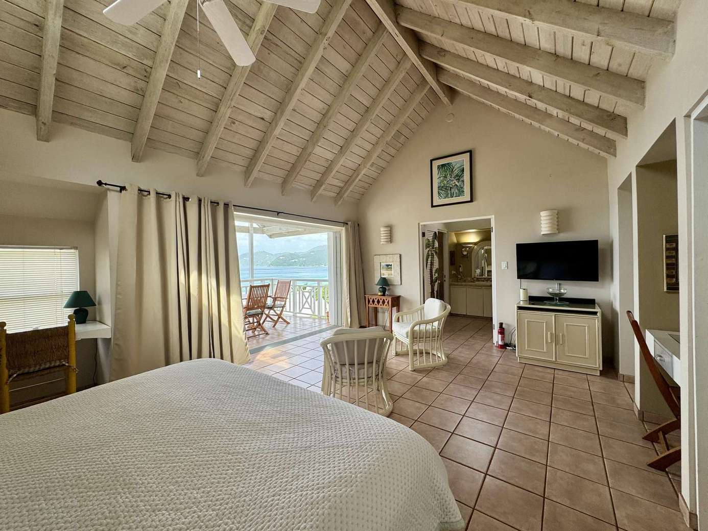 Bright bedroom with vaulted ceilings and ocean views