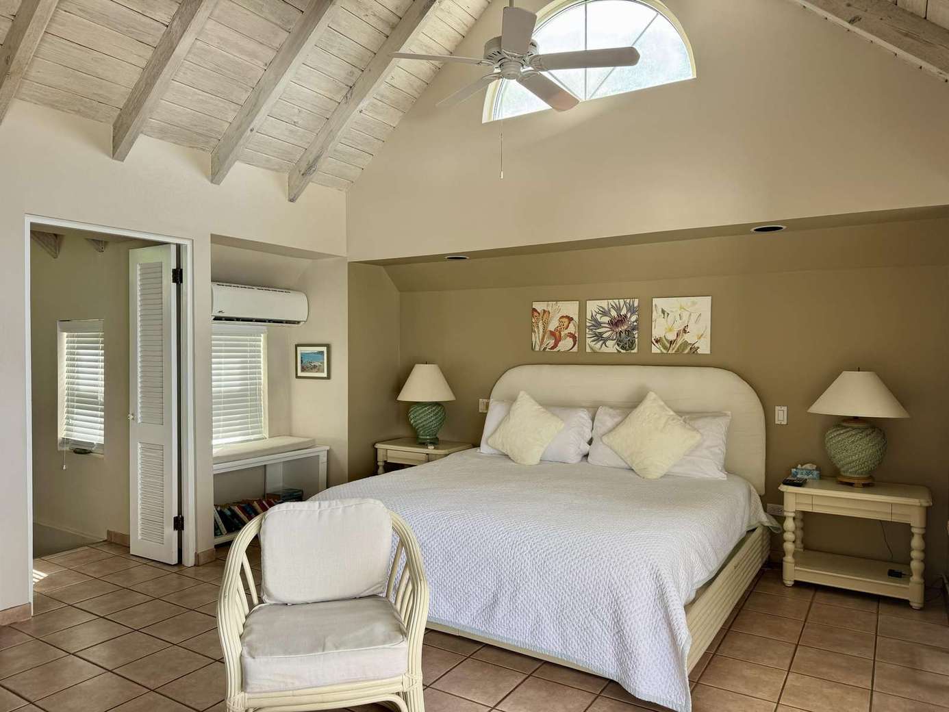 Cozy bedroom retreat with vaulted ceilings and natural light