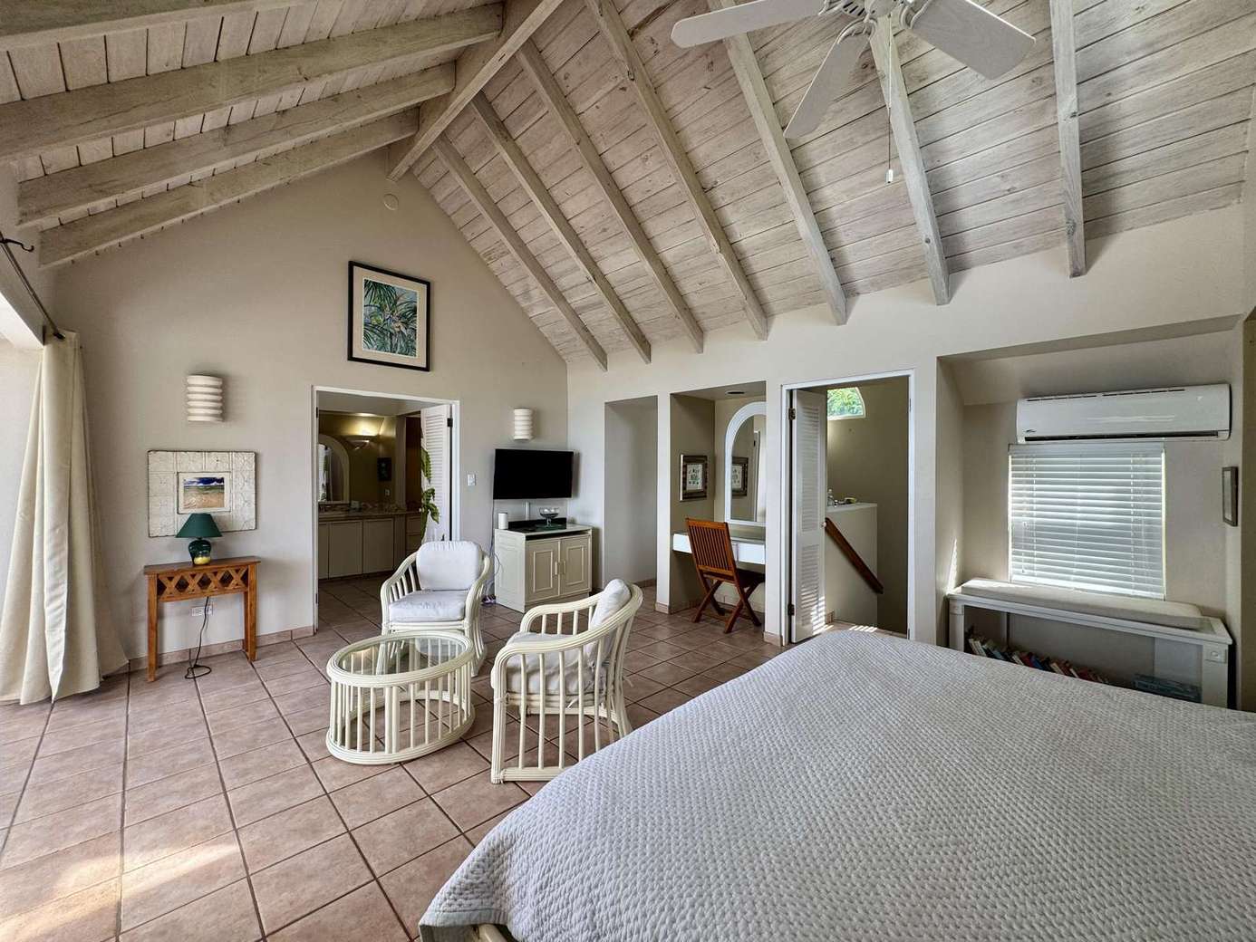 Spacious bedroom retreat with vaulted ceilings and cozy seating area