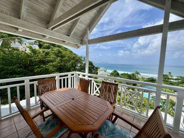 Spacious balcony with ocean views, perfect for relaxing meals