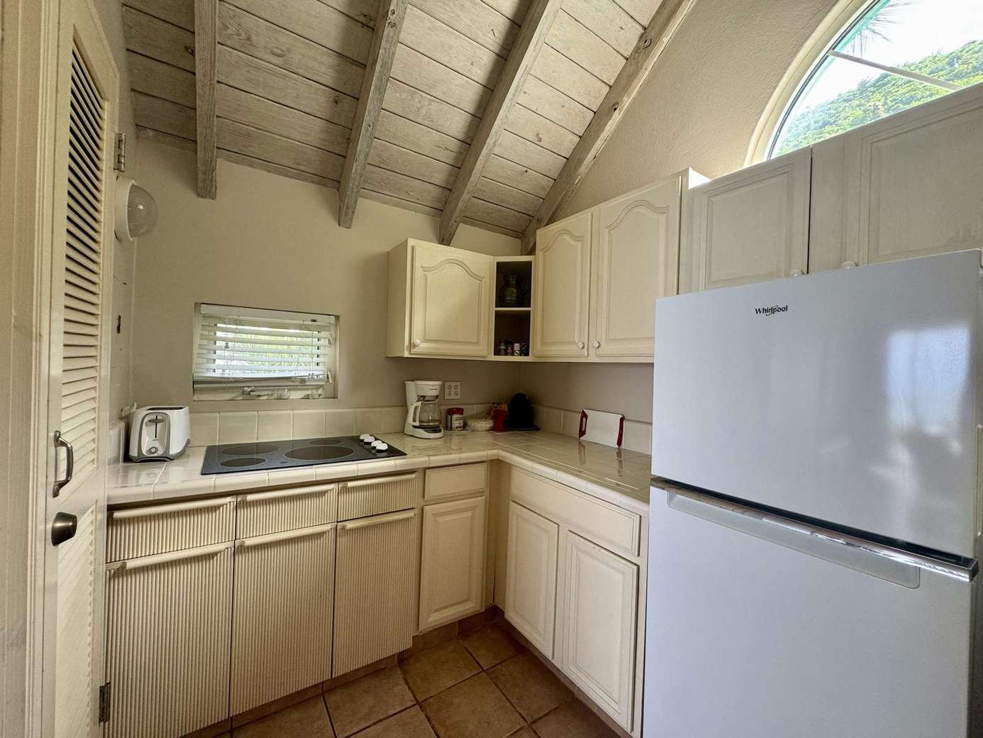 Bright kitchen with vaulted ceilings and cozy charm