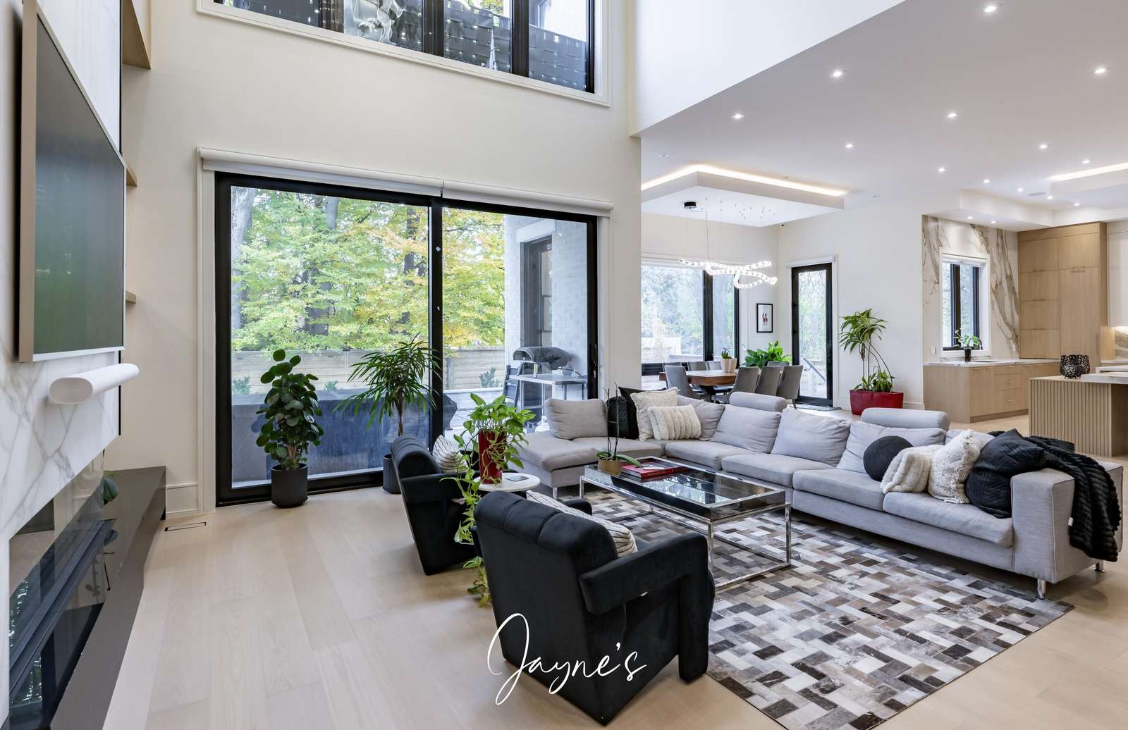 Spacious living room with soaring windows and modern comfort