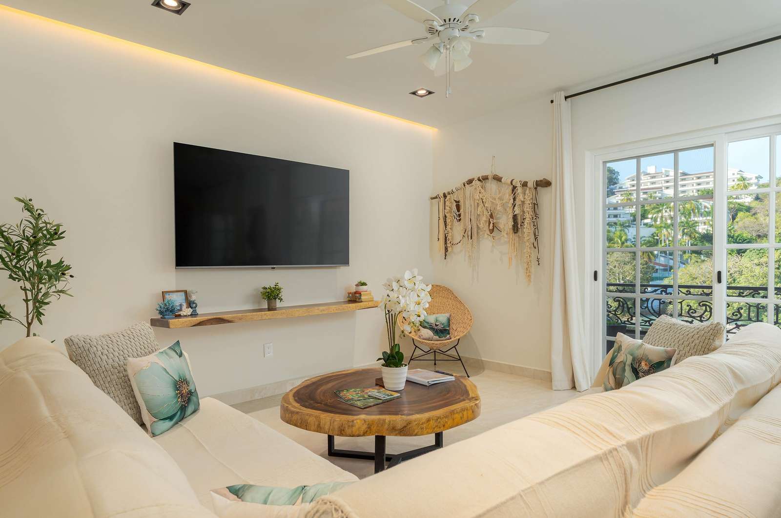 Cozy living room with plush seating and natural light - property