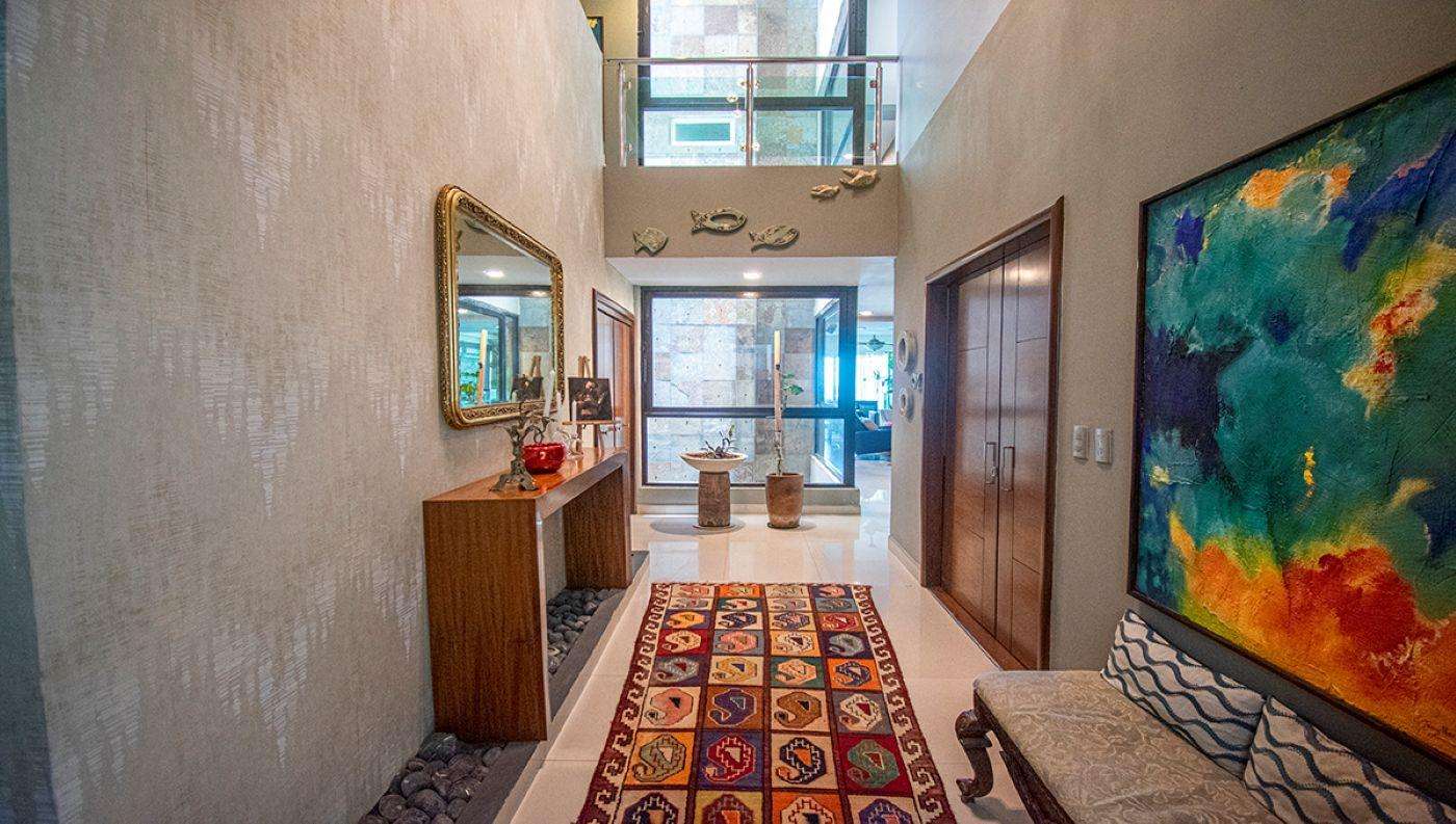 Spacious entryway with vibrant art and natural light - property
