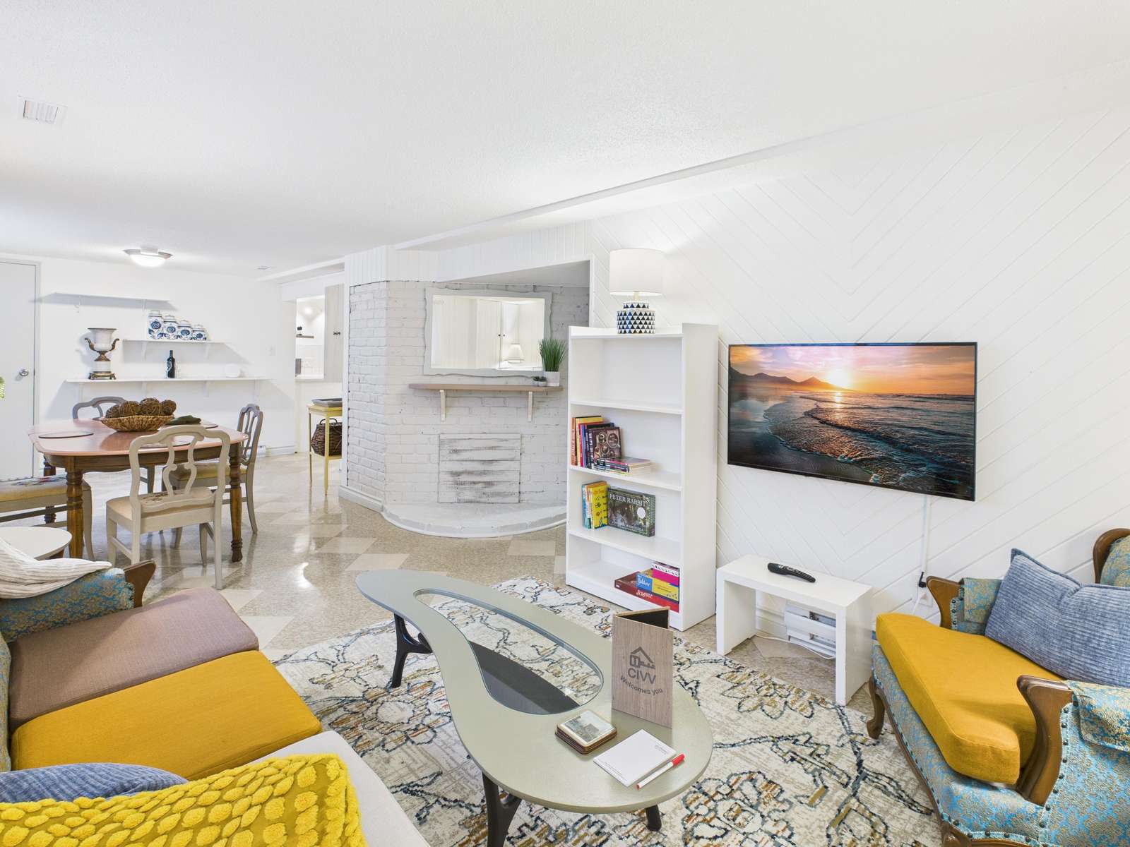 Gather around the tufted sofa in this bright and enjoy movie nights with our 43" Smart TV - property