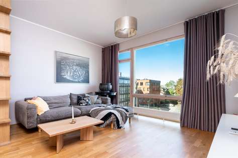 Bright living room with cozy seating and city views