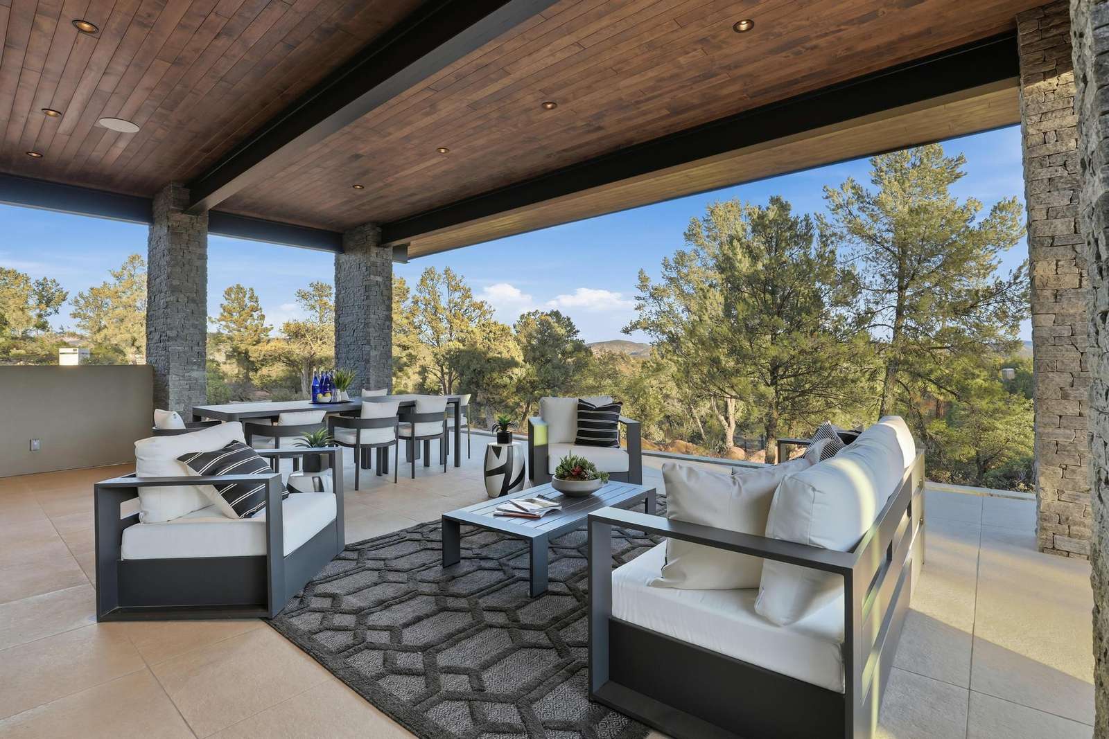 Spacious covered patio with cozy seating and scenic views