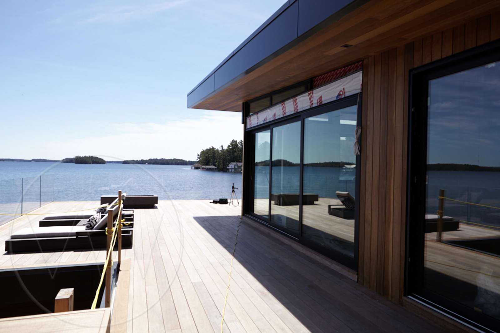 Sunlit waterfront deck with panoramic water views