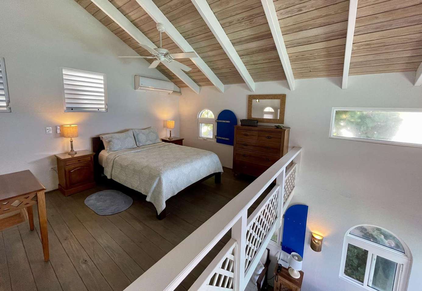 Cozy loft bedroom with vaulted ceilings and warm lighting