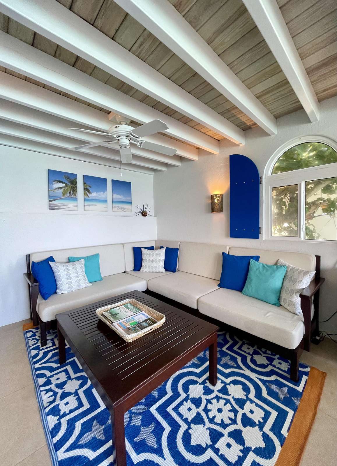 Cozy living room with vibrant blue accents and natural light