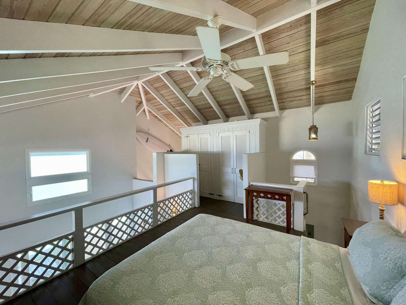 Cozy loft bedroom with vaulted ceilings and natural light
