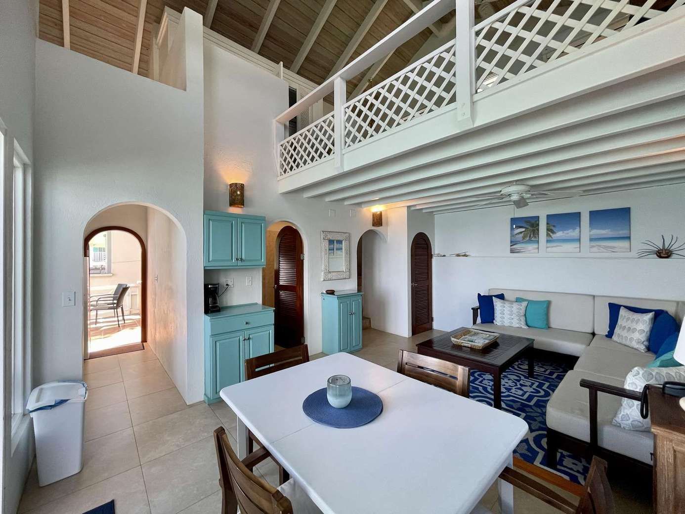 Spacious living and dining area with vaulted ceilings and cozy fireplace