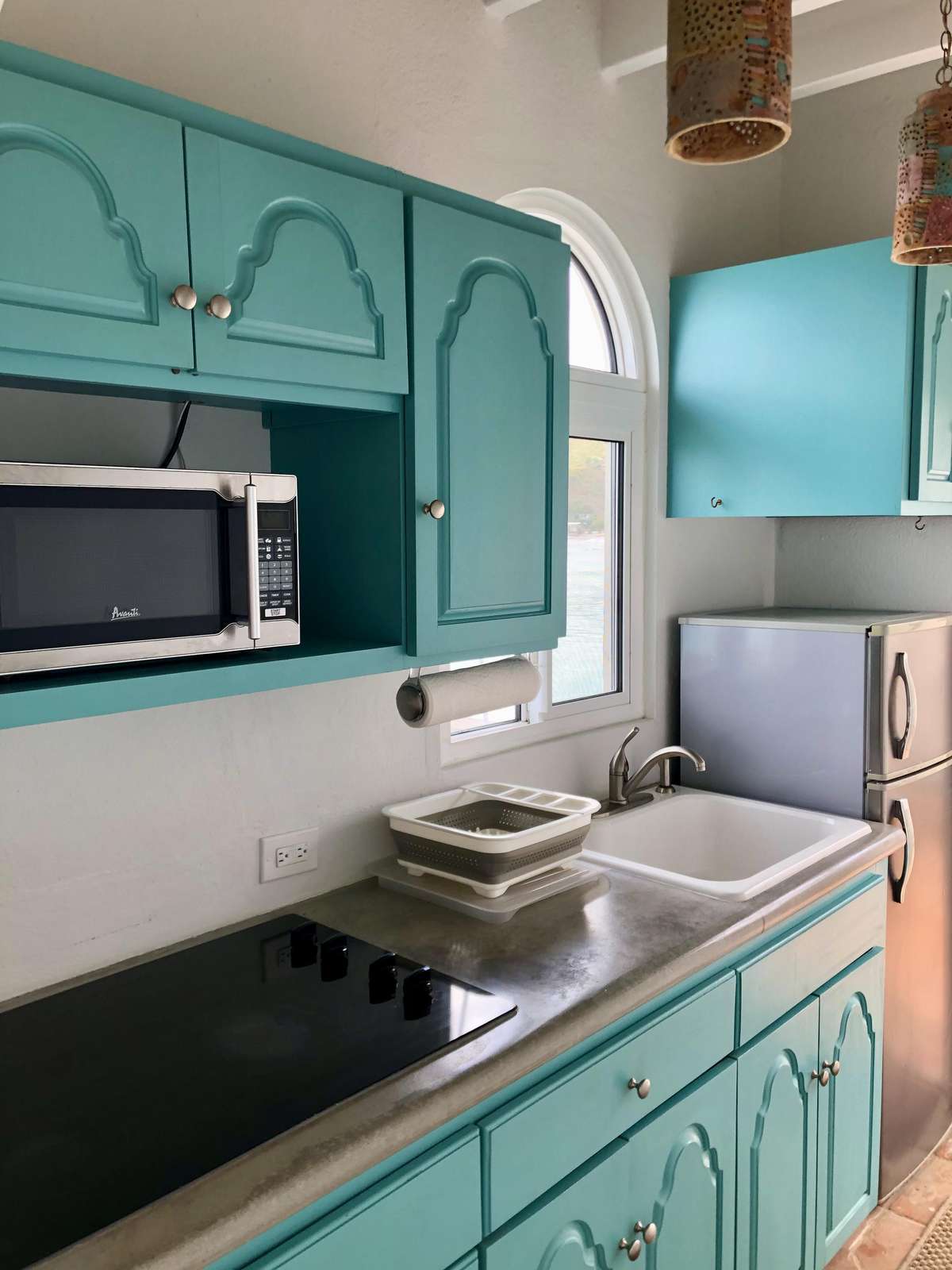 Charming turquoise kitchen with modern appliances and cozy vibes