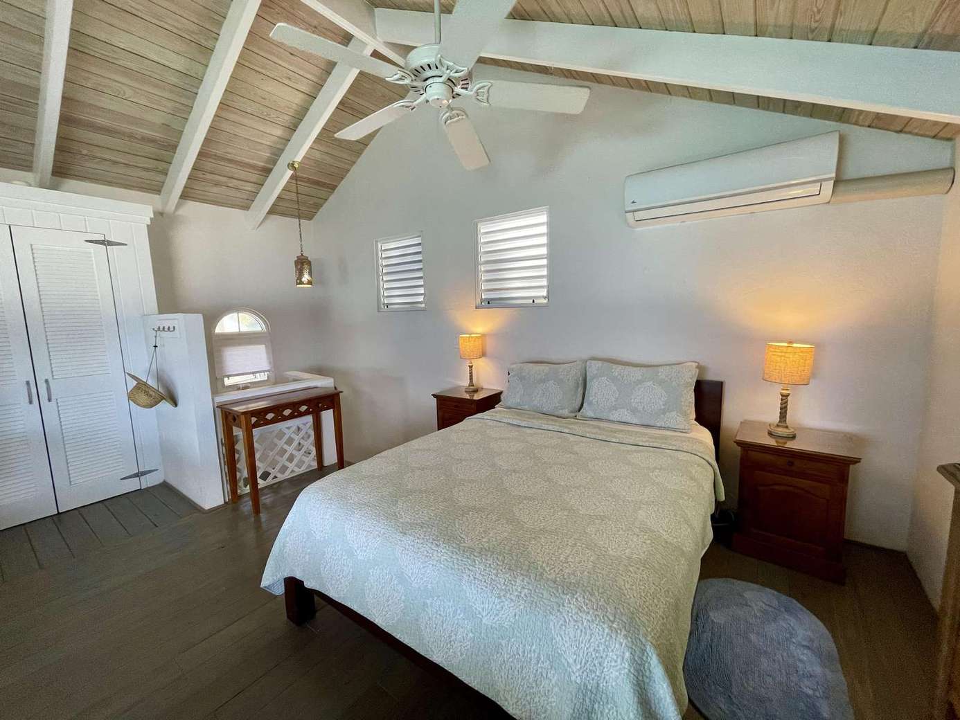Cozy bedroom retreat with vaulted ceilings and warm lighting