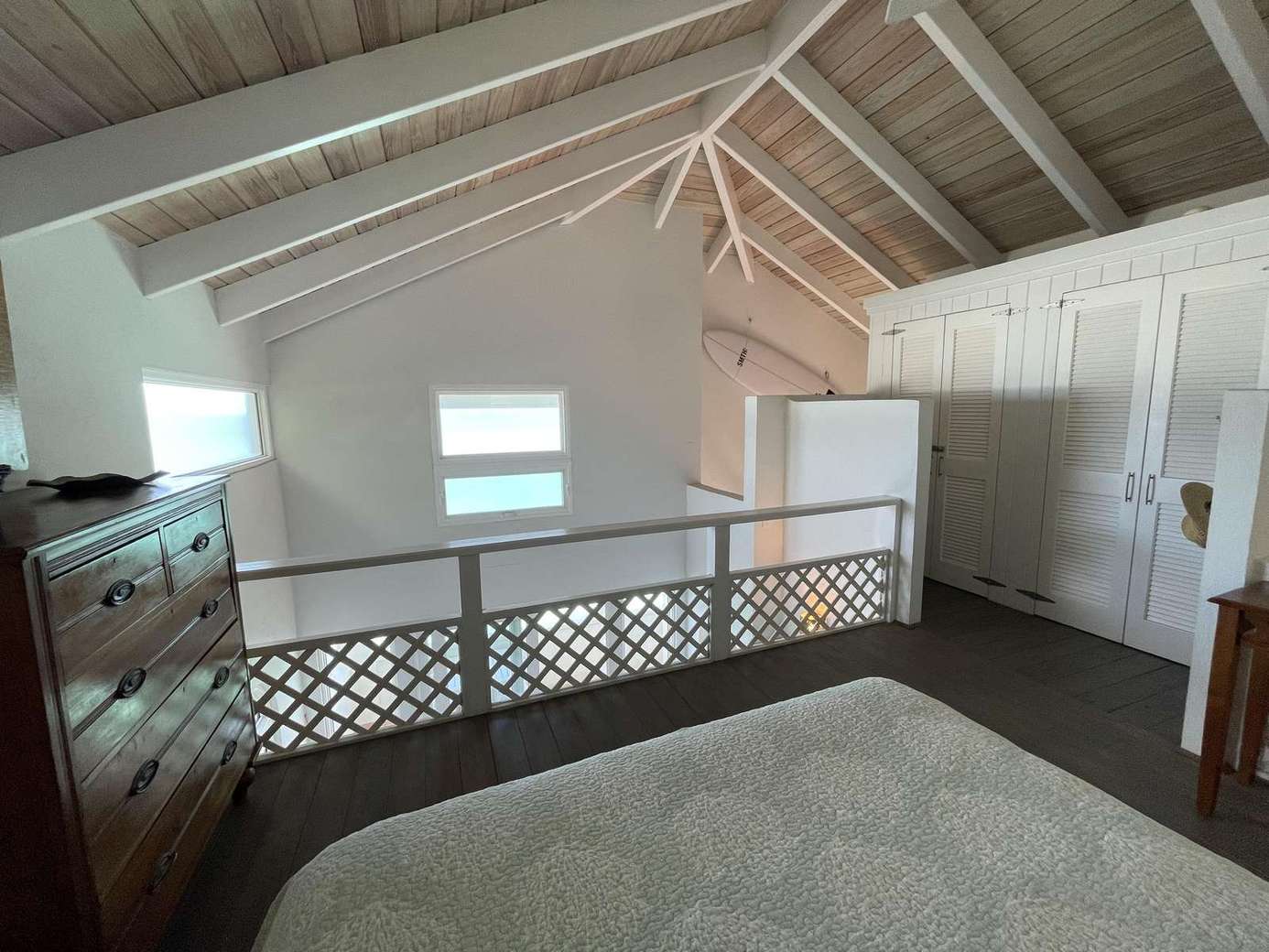Cozy loft bedroom with vaulted ceilings and charming details