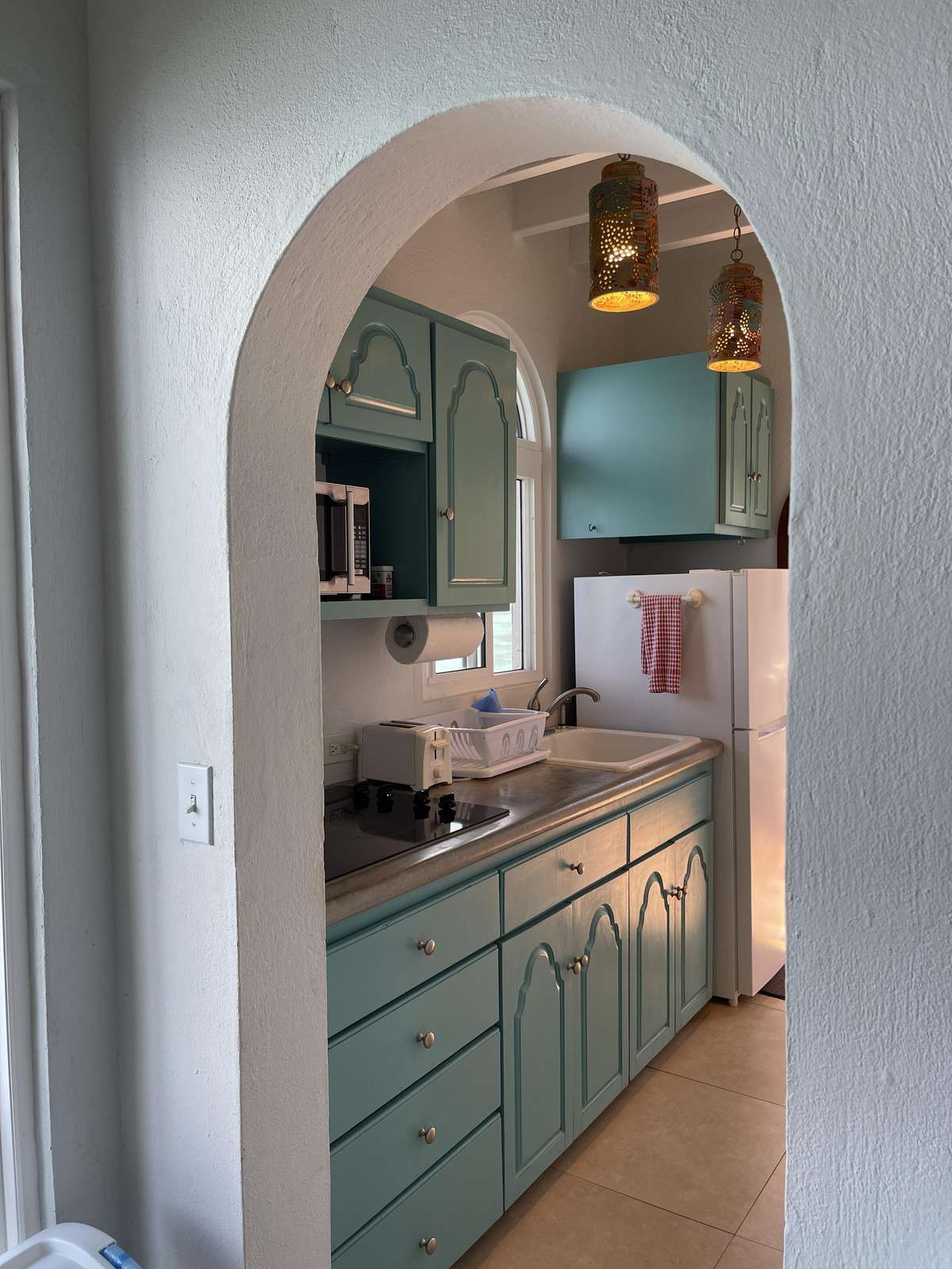 Charming kitchen with vintage cabinetry and cozy arches