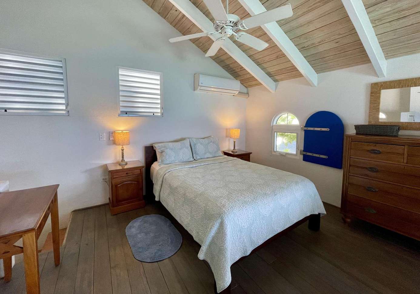 Cozy bedroom with vaulted ceilings and warm lighting