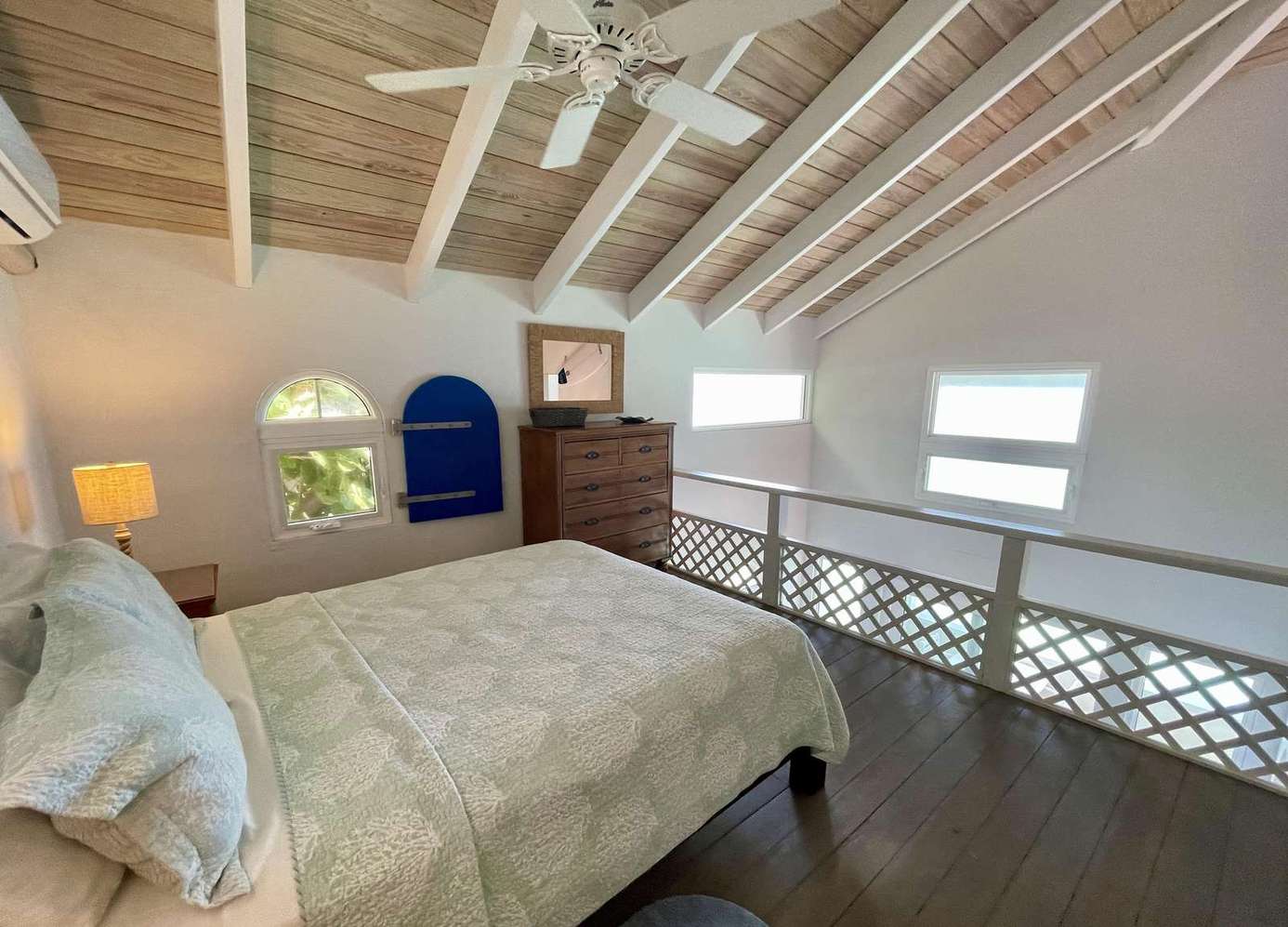 Cozy loft bedroom with vaulted ceilings and natural light