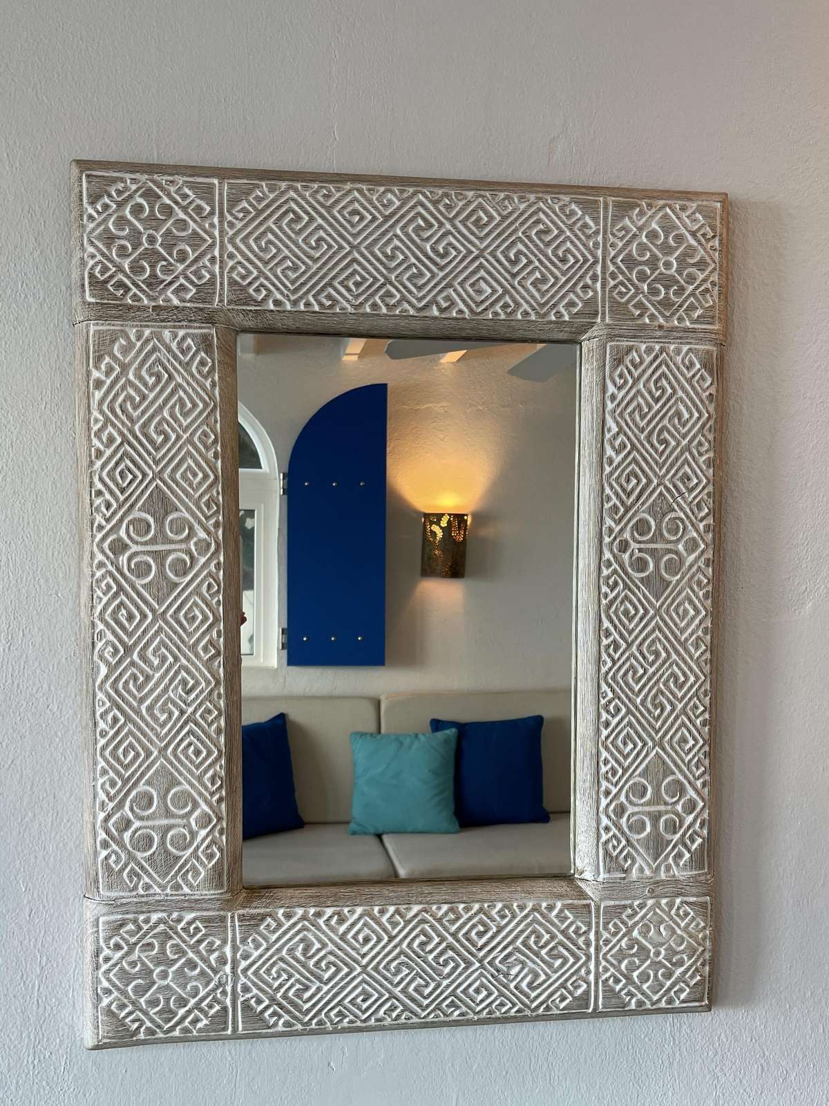 Charming carved mirror adds character to cozy living space
