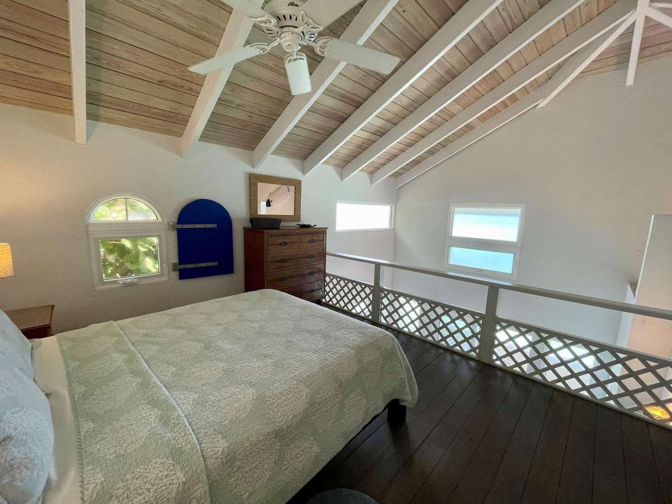 Cozy loft bedroom with vaulted ceilings and ocean views