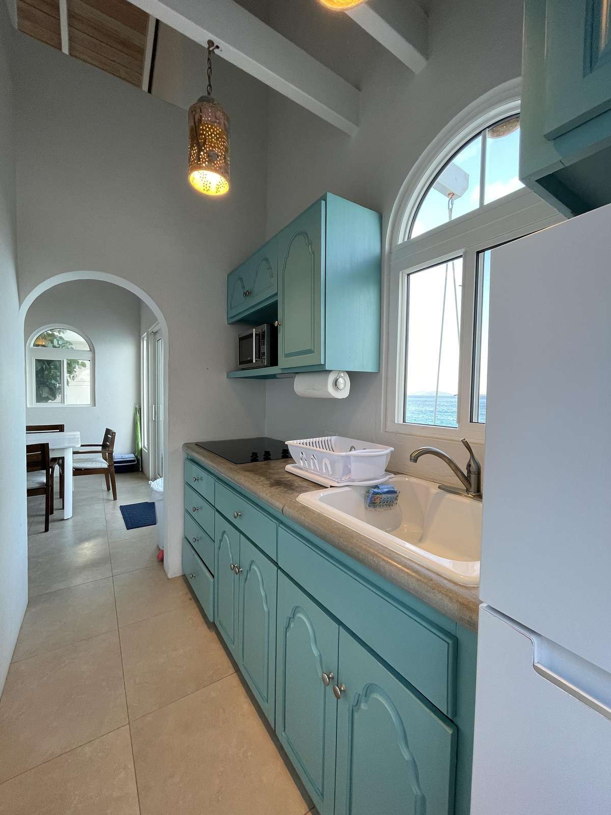 Bright kitchen with vaulted ceilings and charming cabinetry