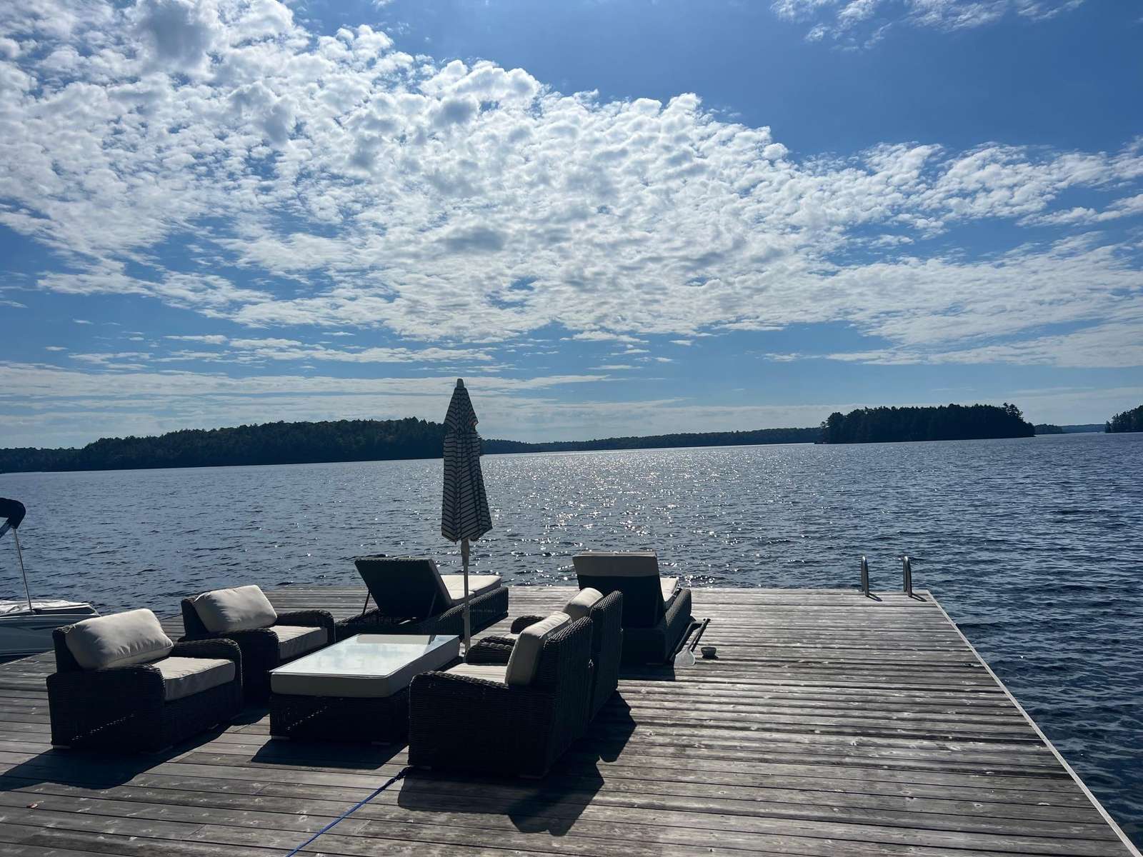 Sun-drenched lakeside dock with cozy seating for sunset views