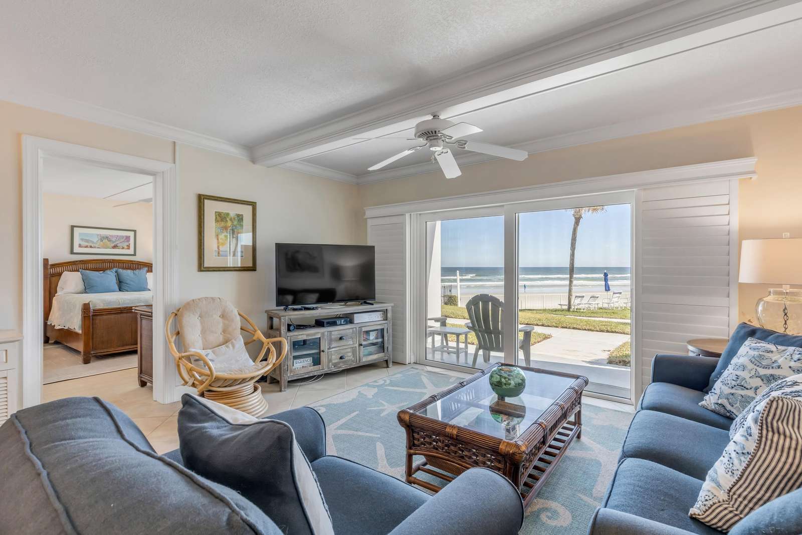 Bright and airy living room with waterfront views and cozy seating - property