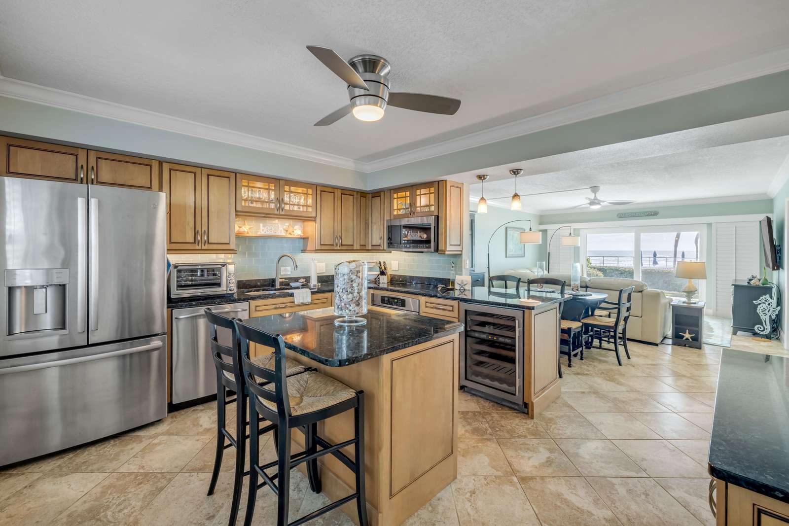 Spacious kitchen with modern appliances and breakfast bar seating - property
