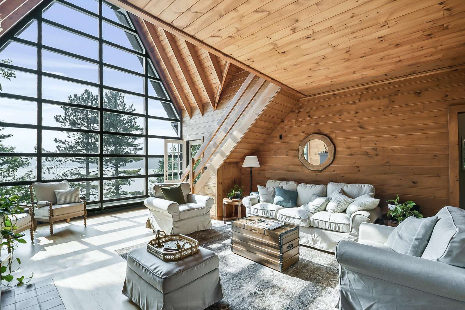 Sunlit living room with vaulted ceilings and cozy seating