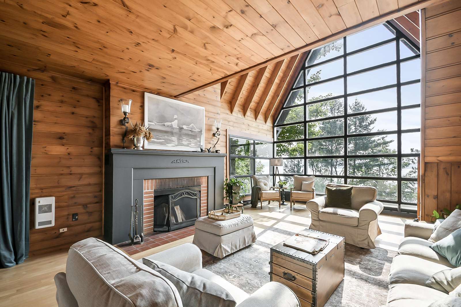 Cozy living room with soaring windows and mountain views