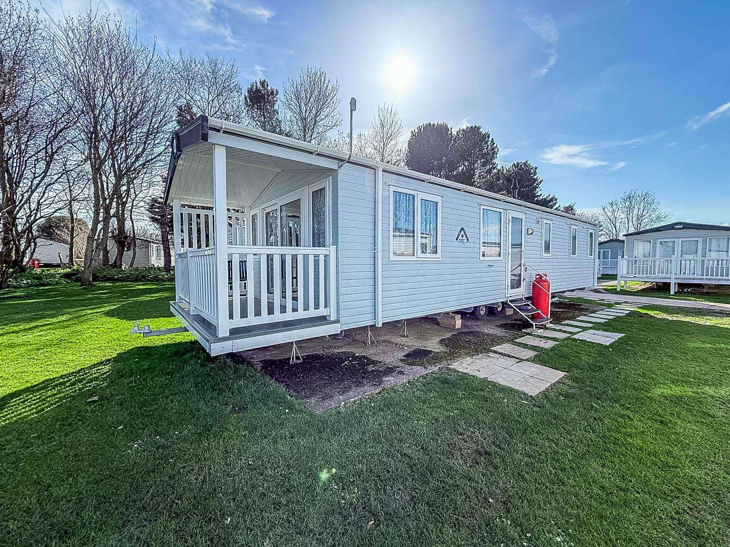 Relax with a morning coffee on the decking of this modern caravan on the Suffolk Coast. - property