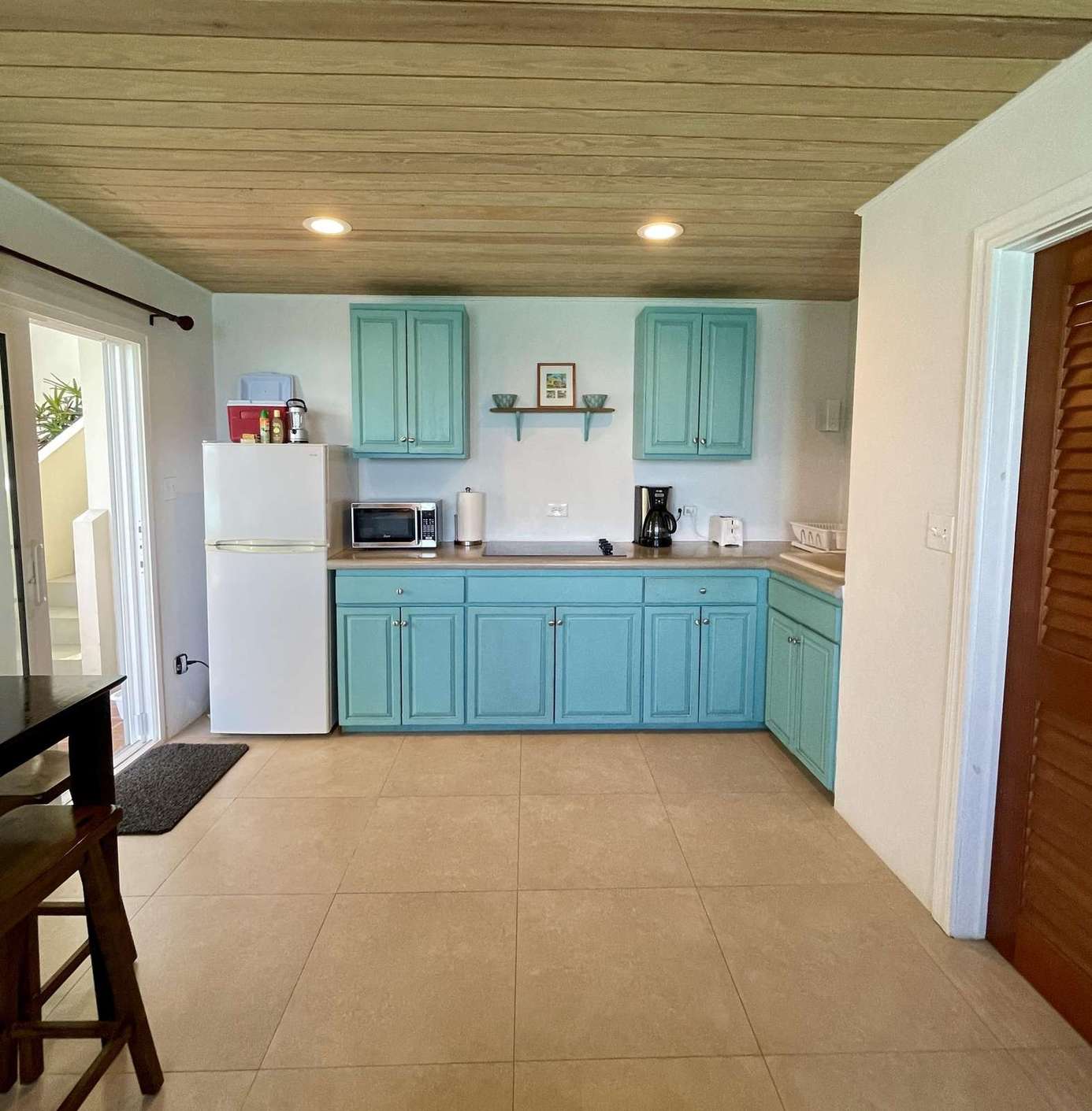 Bright kitchen with retro turquoise cabinets and modern appliances