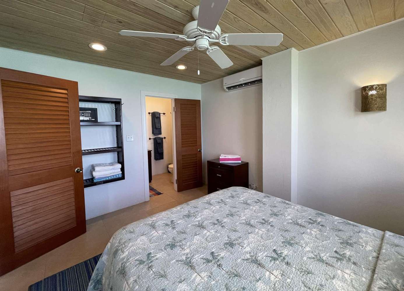 Cozy bedroom retreat with ceiling fan and natural light